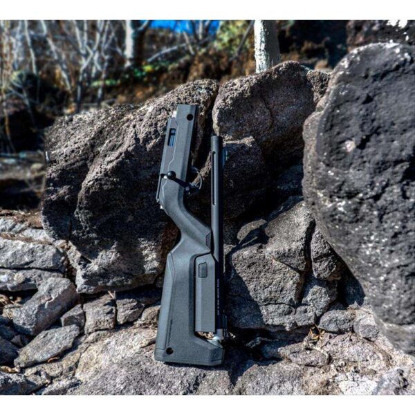 TACTICAL SOLUTIONS OWYHEE TAKEDOWN BOLT ACTION RIFLE TAKEN DOWN SITTING UPRIGHT ON ROCK/HILL