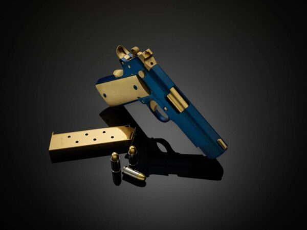 CABOT GUN OF THE MONTH AUGUST ICON ROYALE .45 ACP LEFT SIDE VIEW LAYING FLAT MUZZLE FACING AWAY WITH ACCESORIES
