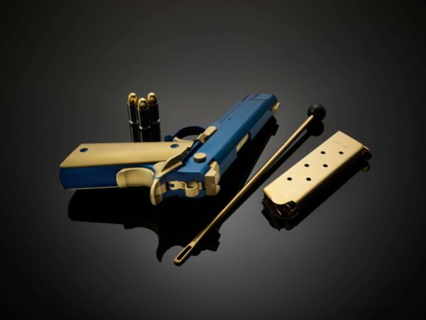 CABOT GUN OF THE MONTH AUGUST ICON ROYALE .45 ACP LEFT SIDE VIEW LAYING FLAT MUZZLE FACING AWAY WITH ACCESORIES