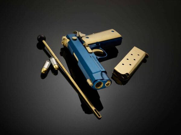 CABOT GUN OF THE MONTH AUGUST ICON ROYALE .45 ACP LEFT SIDE VIEW LAYING FLAT MUZZLE FACING TOWARD WITH ACCESSORIES